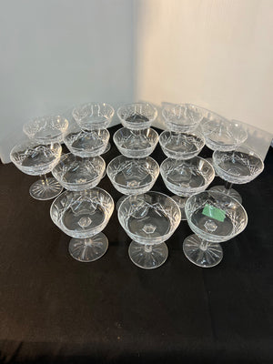Set of clear glass dessert plates on a dark surface