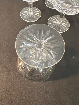 Clear glass coupe with starburst pattern on a dark surface