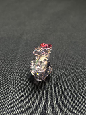 Crystal seashell charm on a textured black background