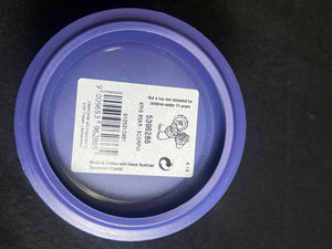 Purple lid with a label on a black background