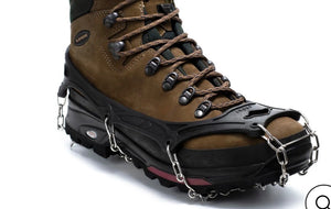 Brown hiking boot with metal crampons on a white background