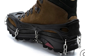 Brown boot with black ice cleats on a white background