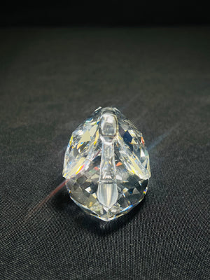 Clear crystal object on a dark fabric background