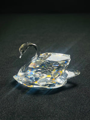 Crystal swan figurine on a black background