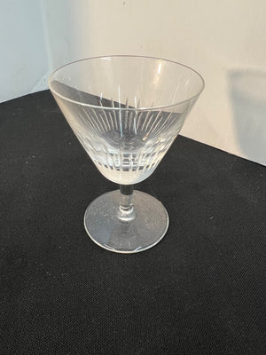 Clear glass with etched design on a black surface