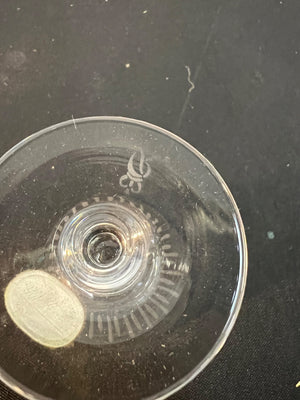 Clear plastic component with gear-like design on a dark background