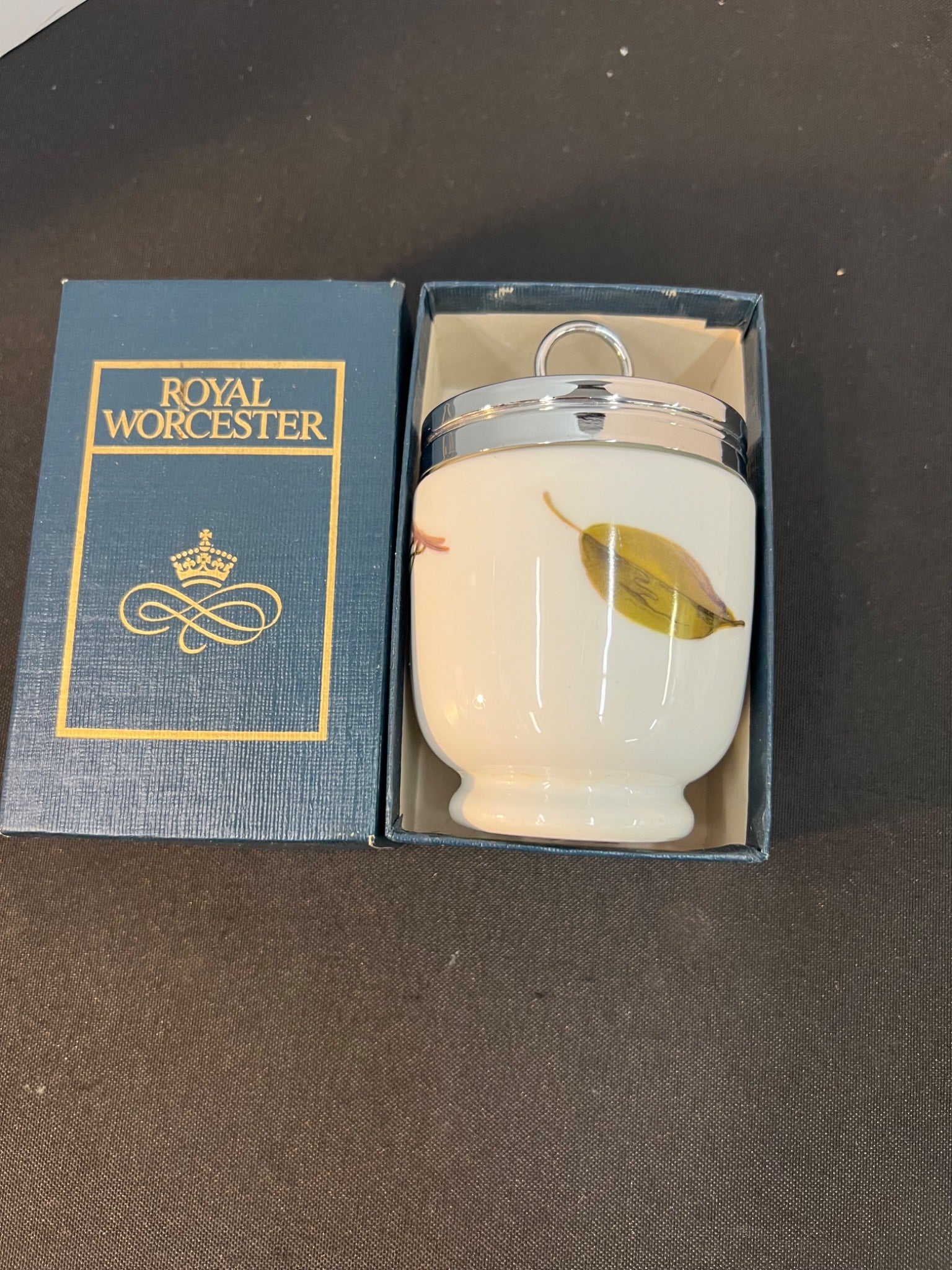 Royal Worcester ceramic item with a leaf design in packaging on a dark surface