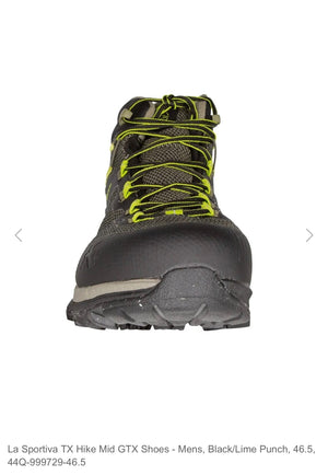 Black hiking boot with yellow laces on a white background