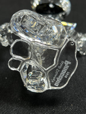Clear plastic skull-shaped object with 'Bog Danes' branding on a black background