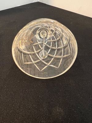 Decorative glass bowl with geometric design on a black surface