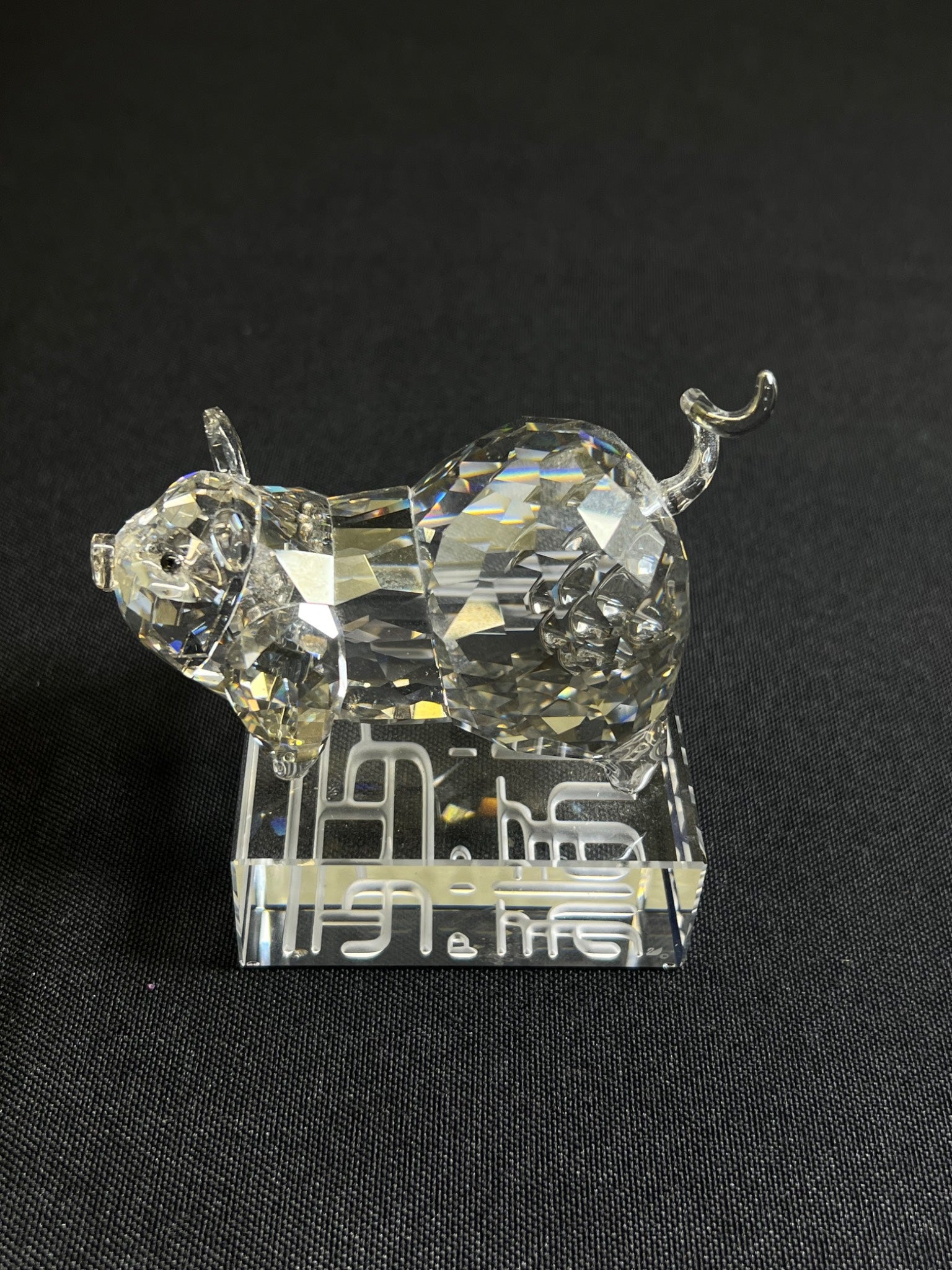 Crystal pig figurine on a black background