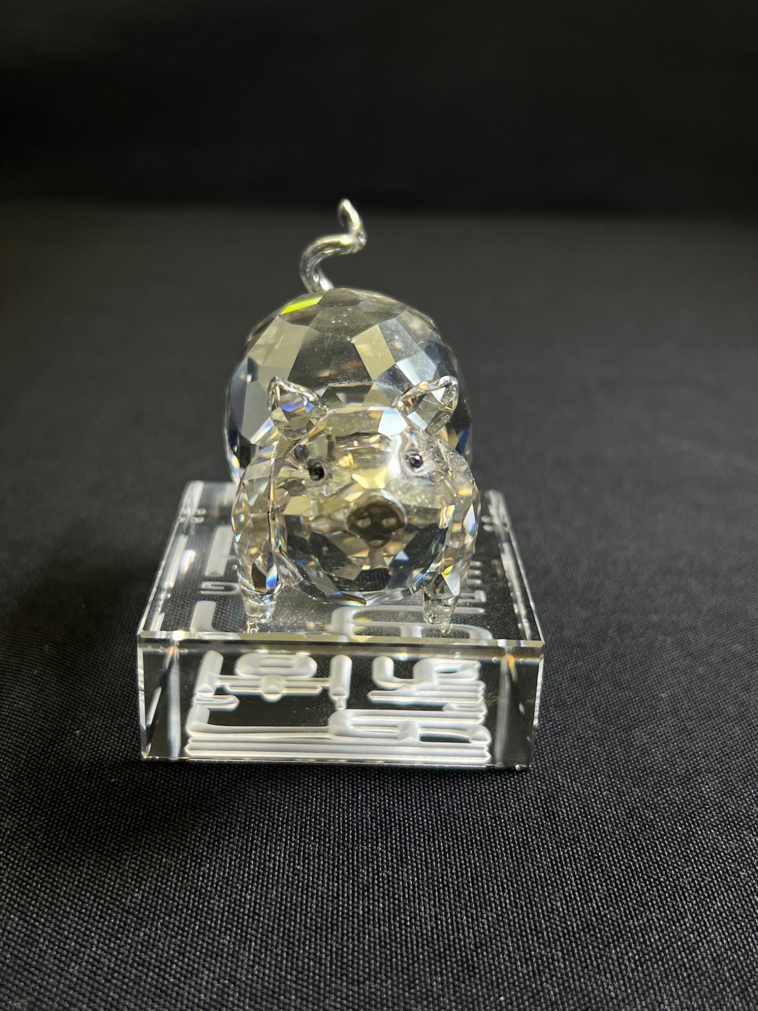 Clear crystal tiger figurine on a black background