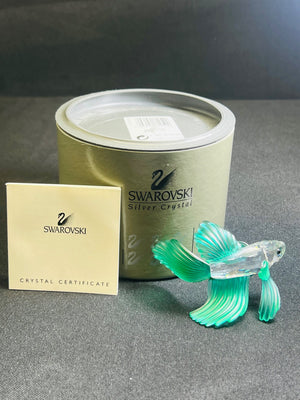 Swarovski crystal fish figurine with packaging and certificate on a gray surface