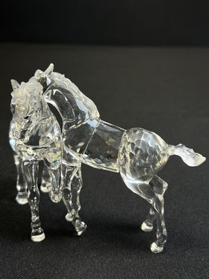 Clear glass horse figure on a black background