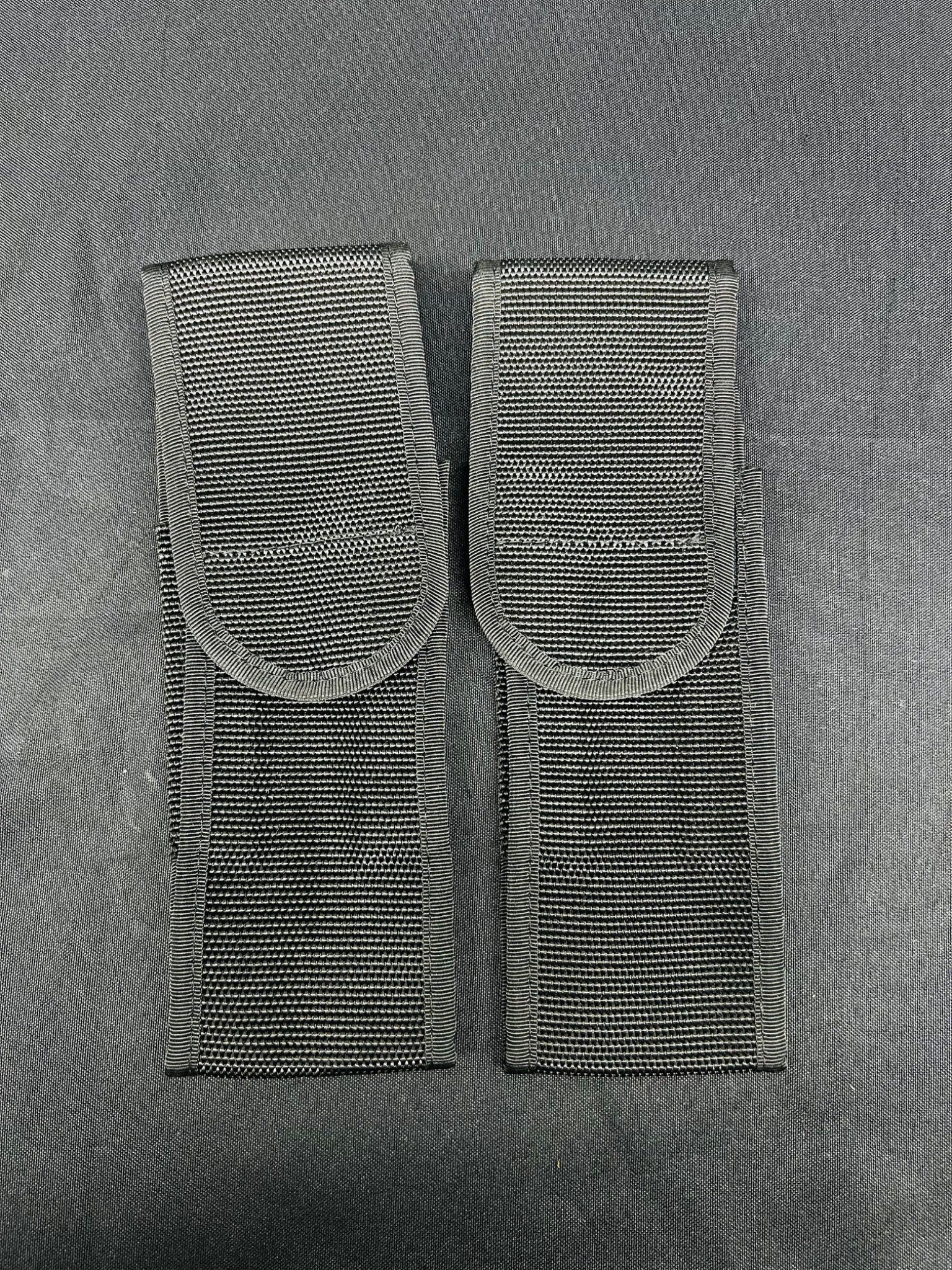 Two gray tactical pouches on a gray background
