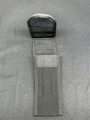 Black tactical knife sheath on a gray background
