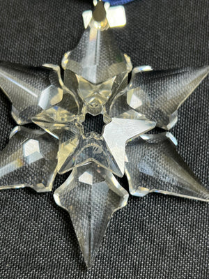 Crystal snowflake ornament on a black background