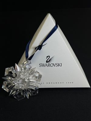 Swarovski crystal ornament with packaging on a black background