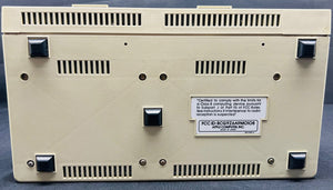 Back view of a beige electronic device with text and certification labels on a blue background