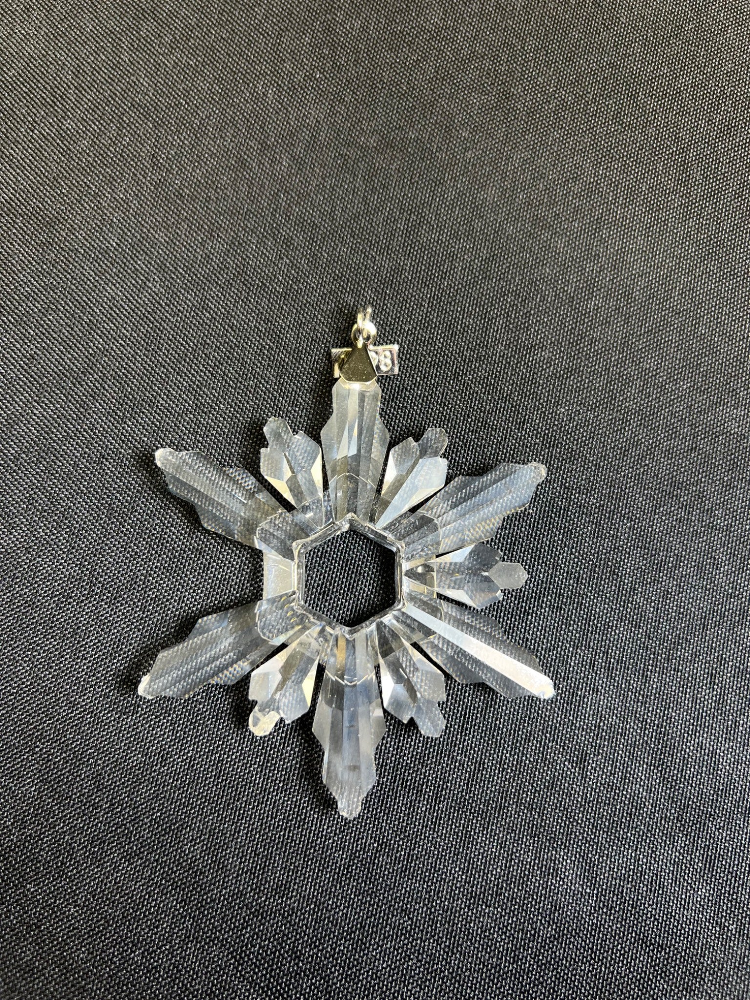 Crystal snowflake ornament on a dark background