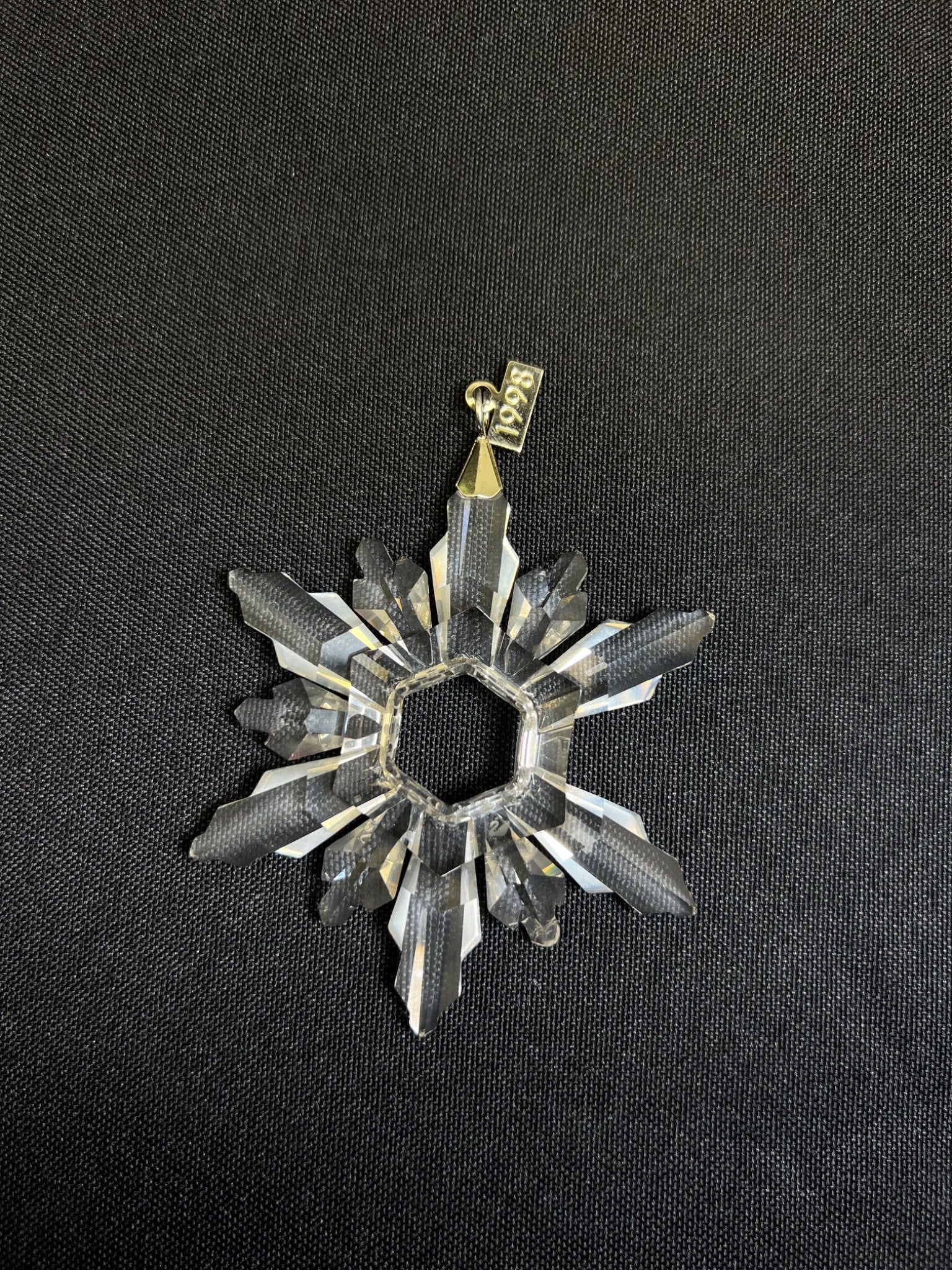 Decorative star-shaped object with a gold accent on a black background