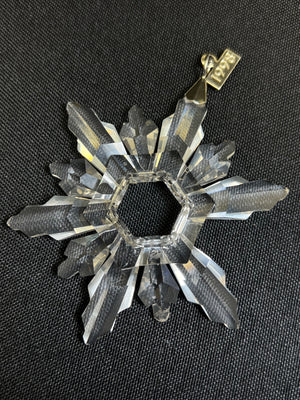 Crystal snowflake ornament on a black background