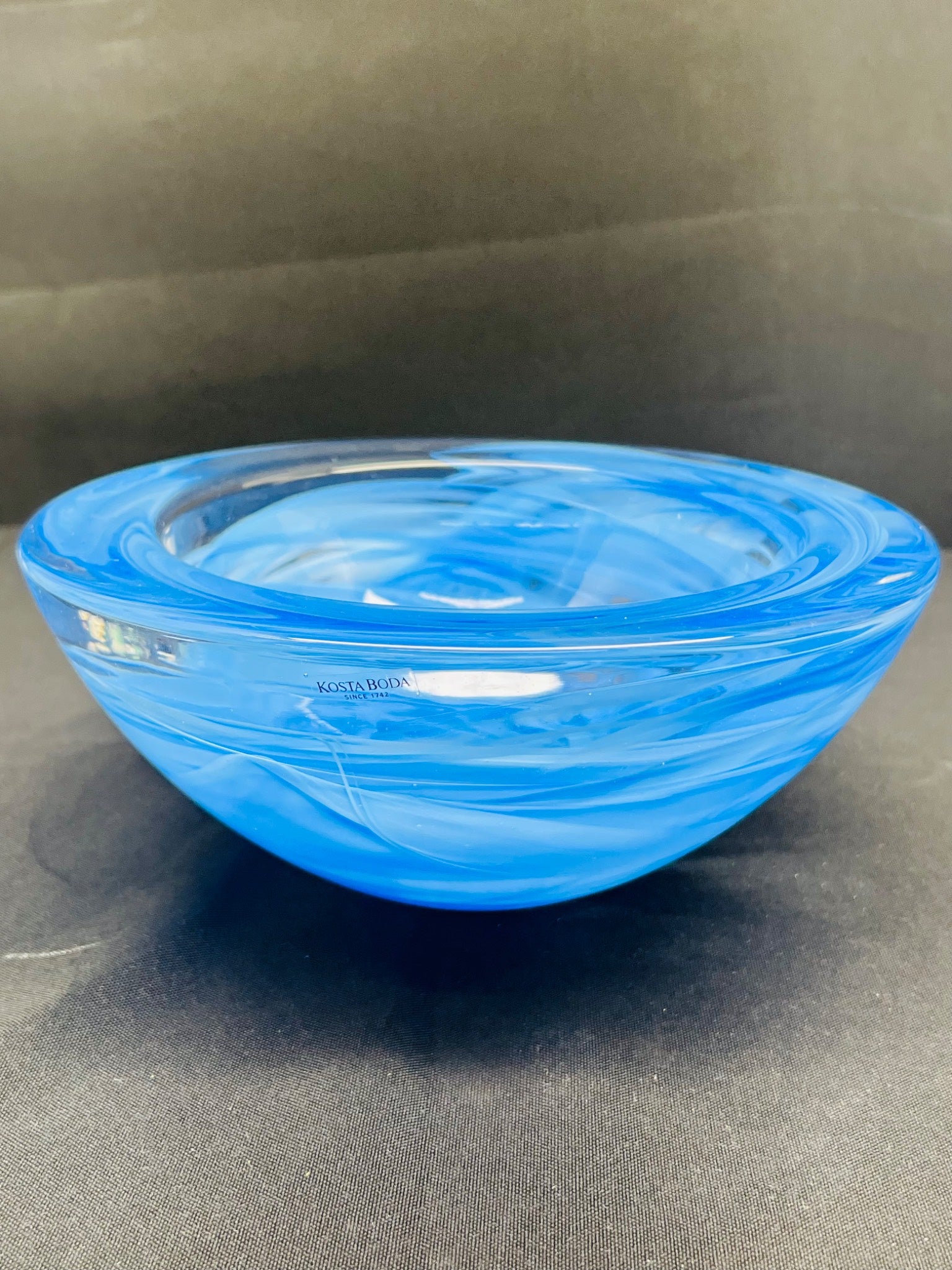 Blue glass bowl on a dark gray background