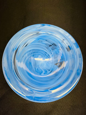Clear blue glass bowl on a dark background