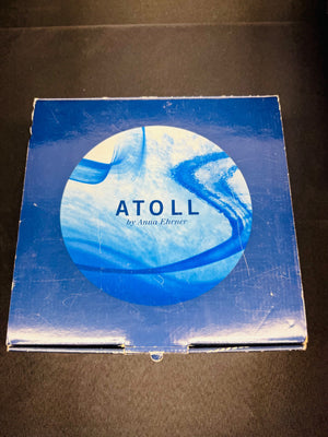 Product packaging with 'ATOLL' branding on a dark background