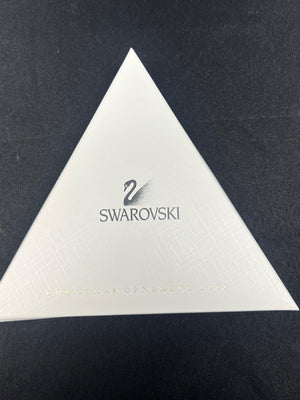 White triangular Swarovski product on a dark background