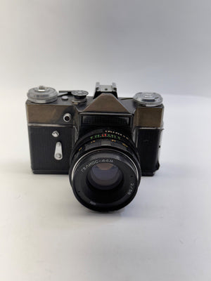 Vintage camera with a prominent lens on a white background