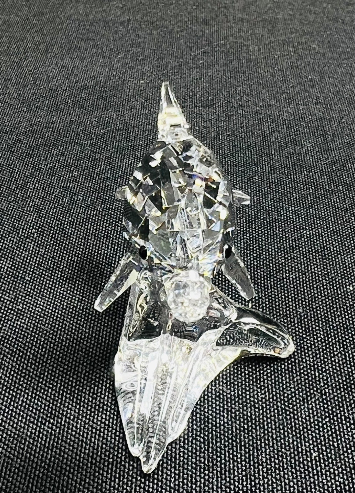 Clear crystal object on a textured black surface