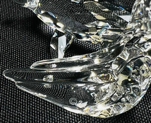 Crystal butterfly figurine on a black textured background