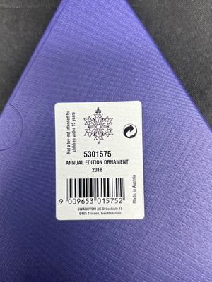 Swarovski annual edition ornament label on a purple background