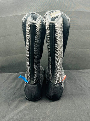 Pair of gray and black riding boots on a gray background