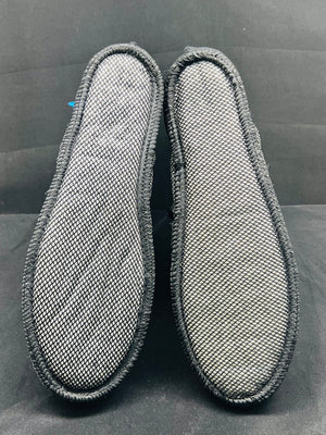 Pair of gray shoe inserts on a black background