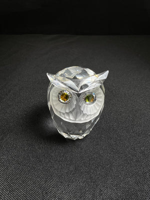 Crystal owl figurine on a black background