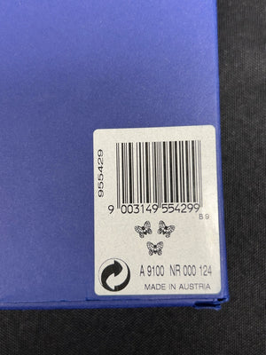 Bar code label on a blue surface with text and symbols.