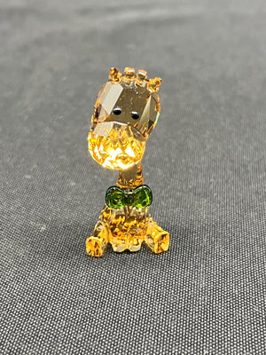 Crystal figurine of a character on a gray textured background