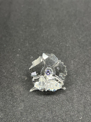 Crystal butterfly figurine on a dark textured surface