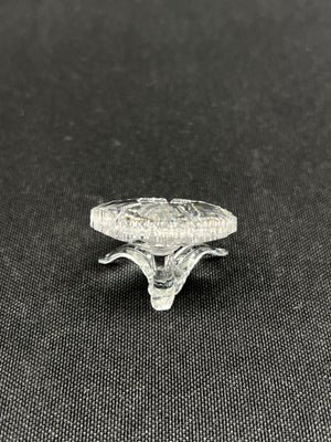 Clear glass knob on a black textured background