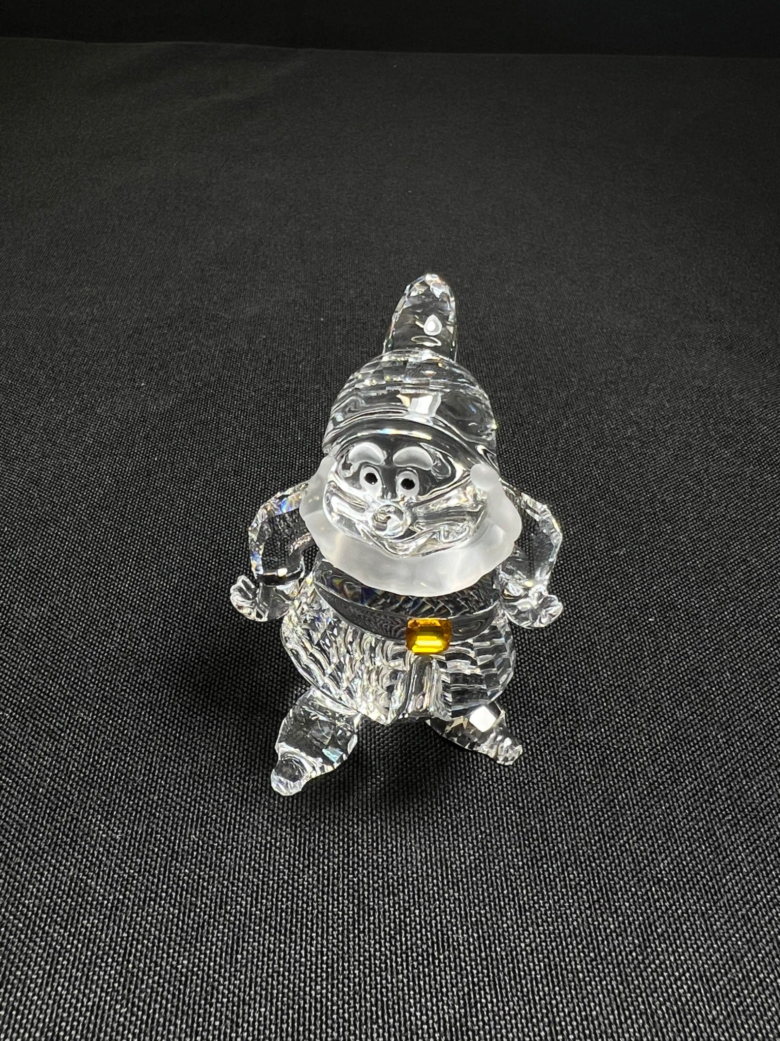 Crystal gnome figurine on a black background
