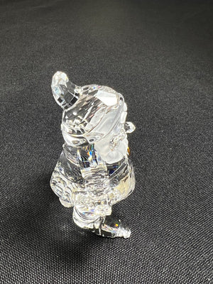 Clear crystal figurine of a dog on a dark gray background