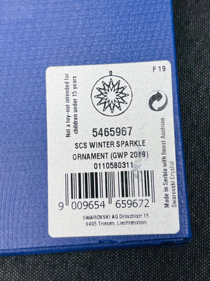 Label on a blue ornament packaging with product details and SCS Winter Sparkle branding.