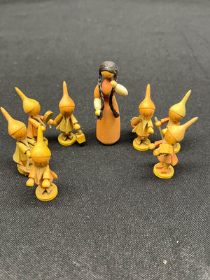 Set of figurines with a central figure on a dark textured background