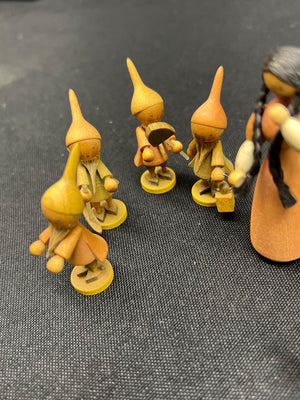 Set of small figurines with pointed hats on a textured surface