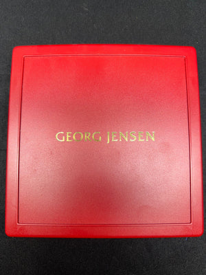 Red Georg Jensen jewelry box on a black background