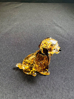 Crystal dog figurine on a gray fabric background