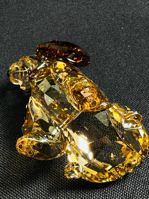 Crystal bear figurine on a black fabric background