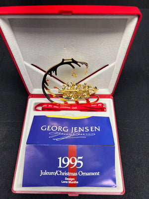 Georg Jensen 1995 Christmas ornament in a red and white box with a blue card.